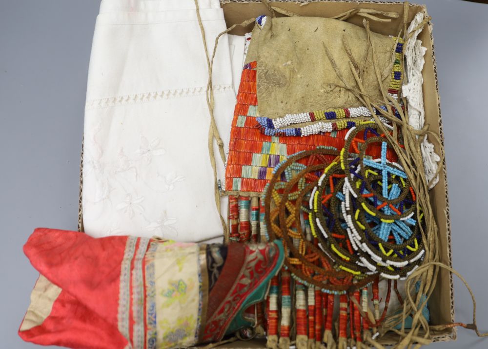 A native North American North Plains beaded leather pouch, a pair of Chinese embroidered shoes, further beadwork roundels and assorted